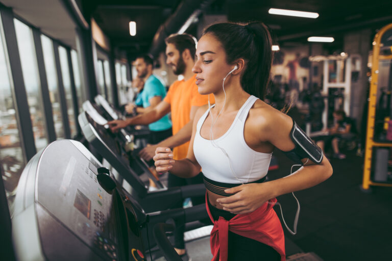 Young woman exercising on treadmill